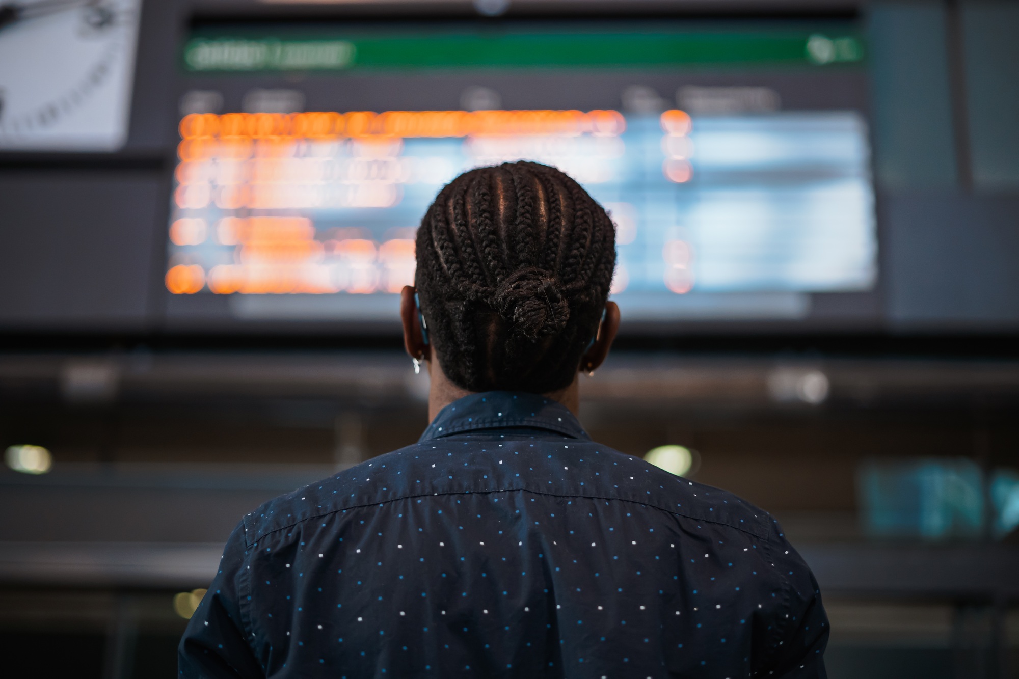 Man looking at the arrivals and departures schedule