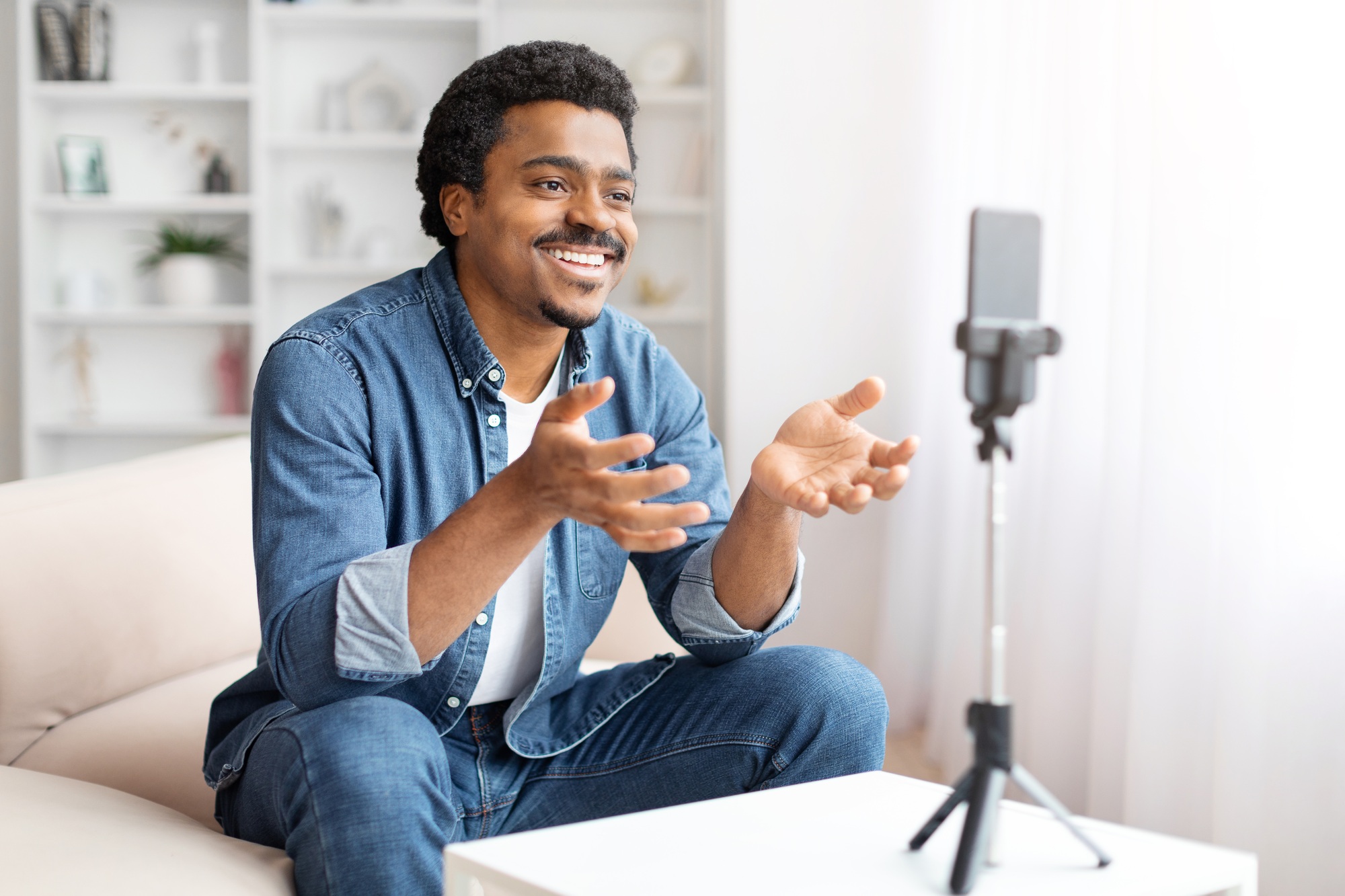 Man recording a video on smartphone at home