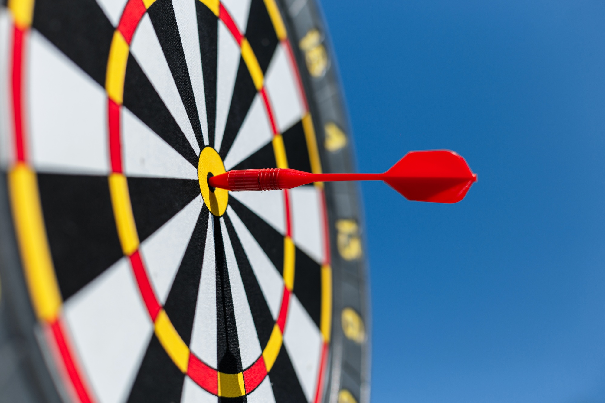 Marketing time concept. Targeting the business. red target and dart arrows on blue sky background
