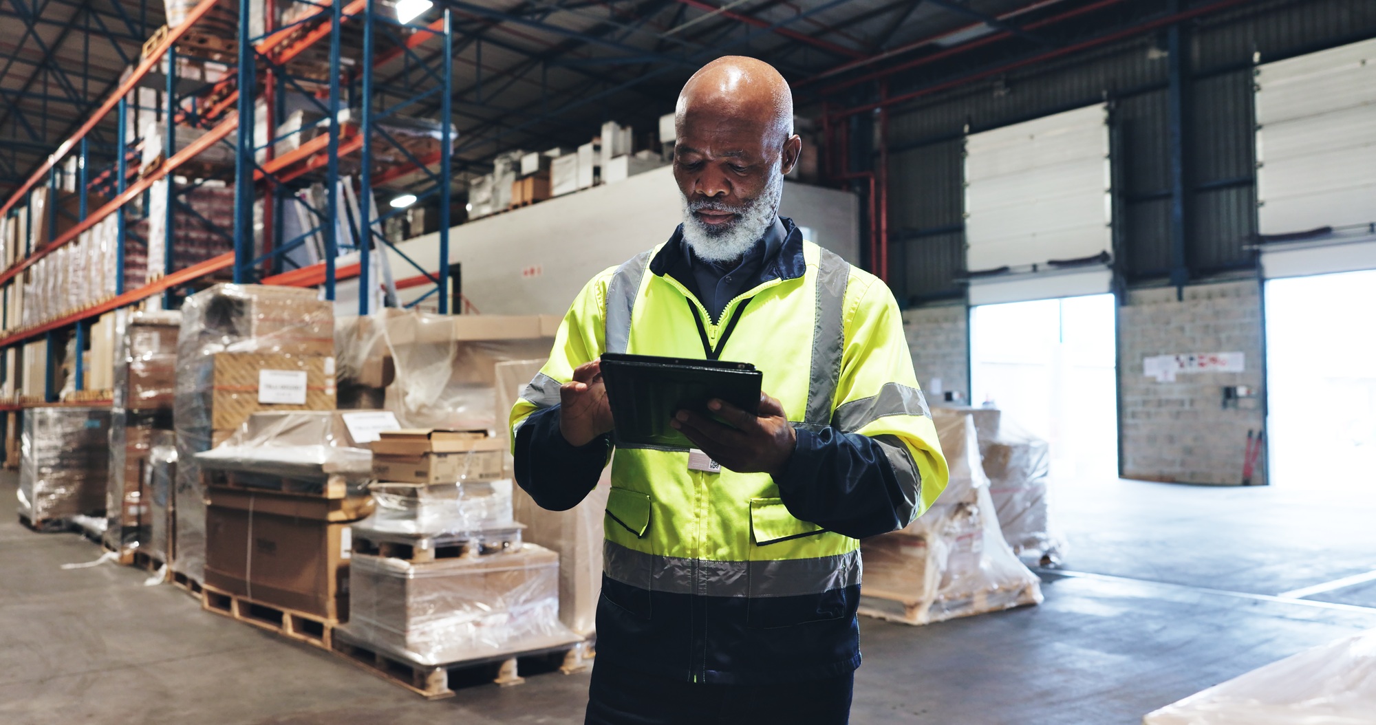 Mature man, online and tablet in warehouse for logistics, inventory check and stock management on w