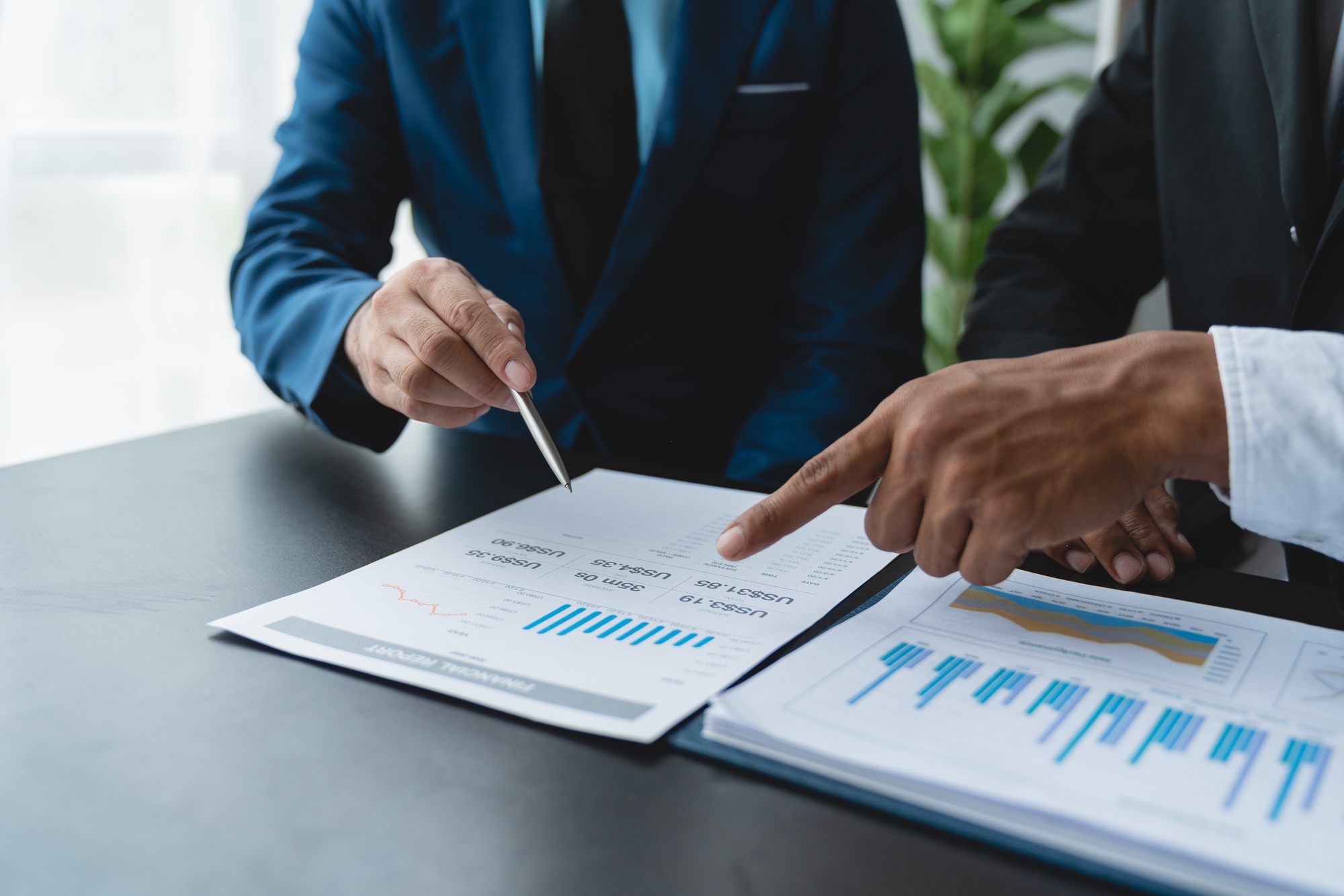 Modern business people meeting with startup projects pointing to discussion calculations and analysi