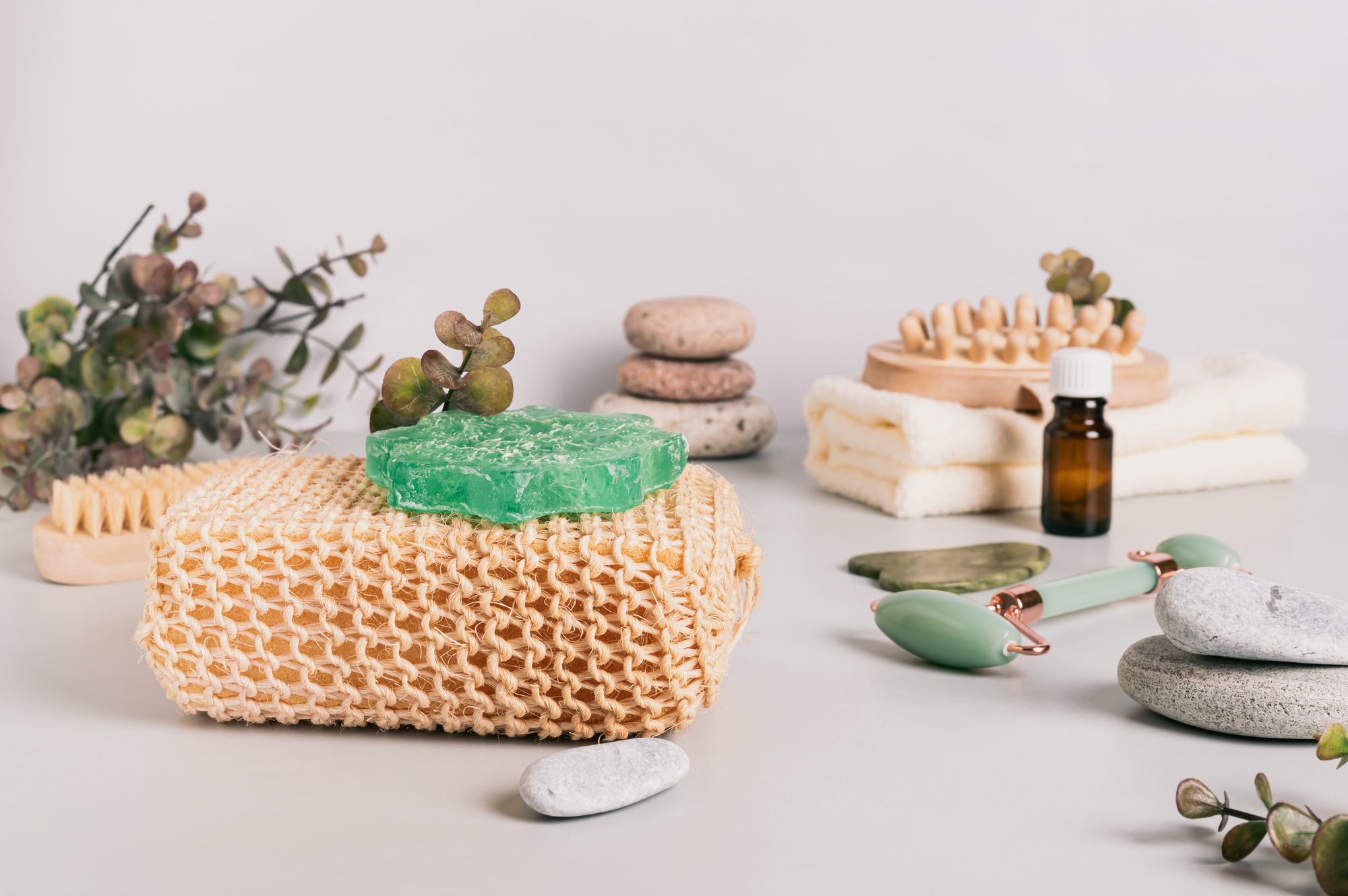 Natural loofah, homemade soap and spa items on table