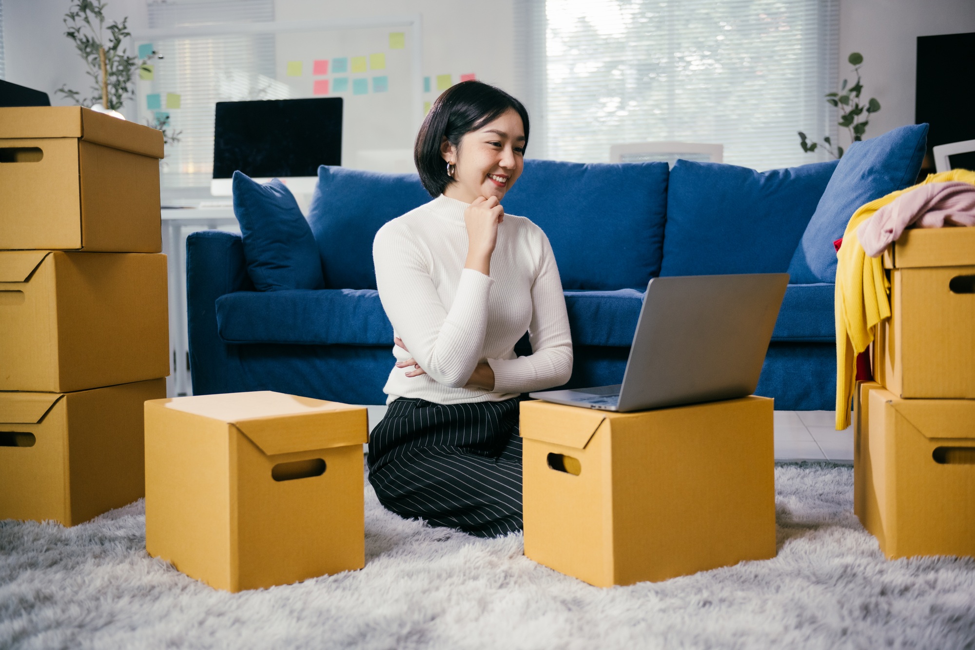 Online seller checking inventory and planning sales strategy using laptop