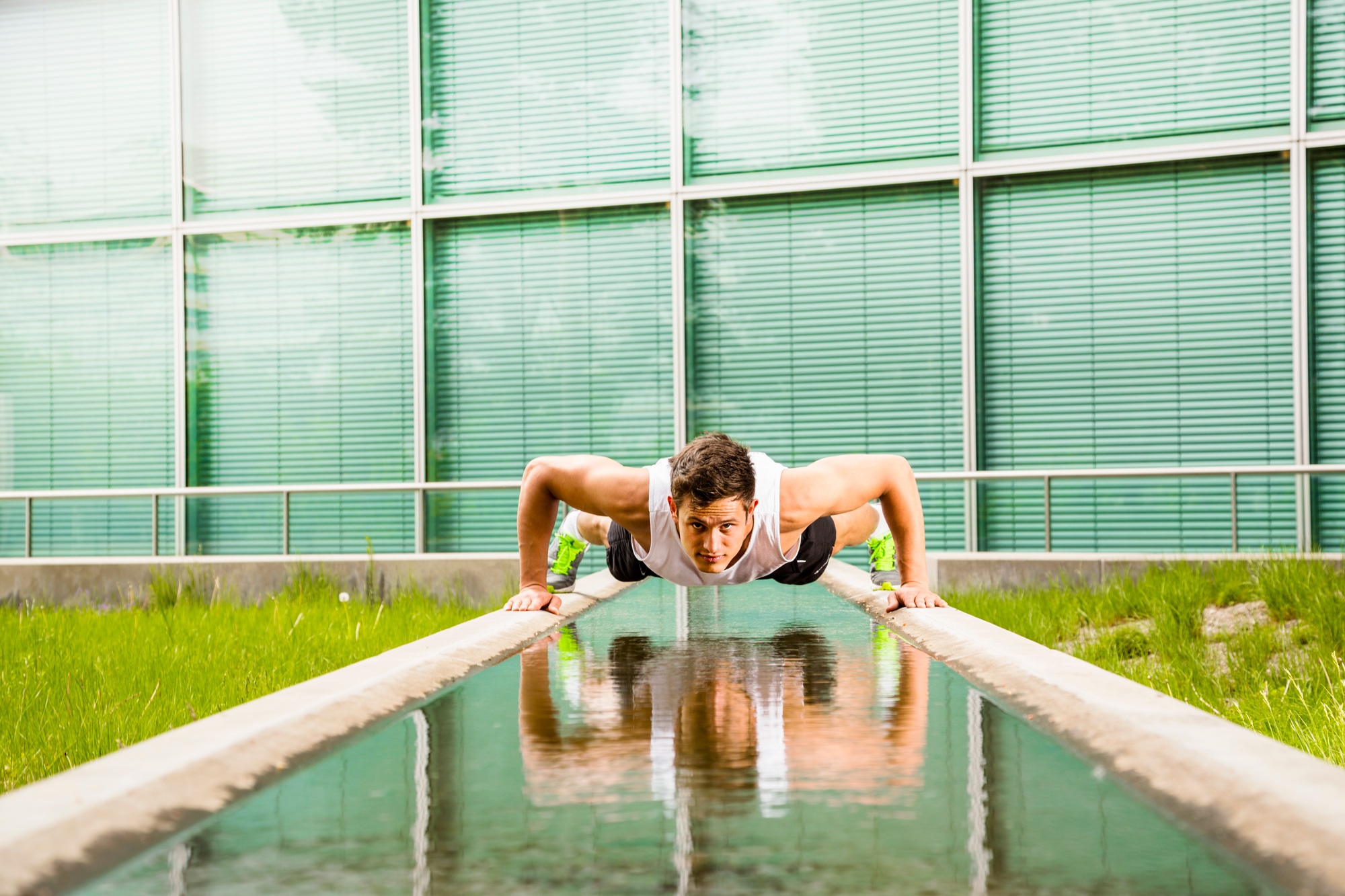 Personal trainer doing outdoor training in urban place, Munich, Bavaria, Germany