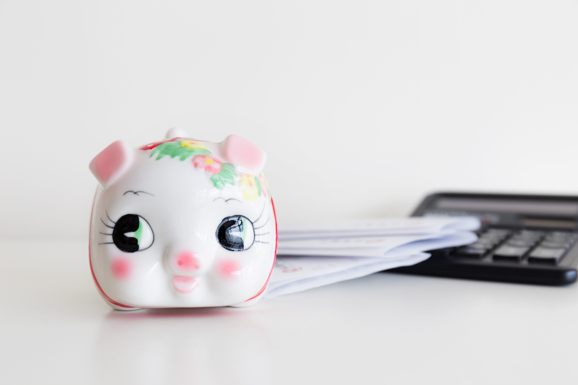 Piggy bank, calculator and statement
