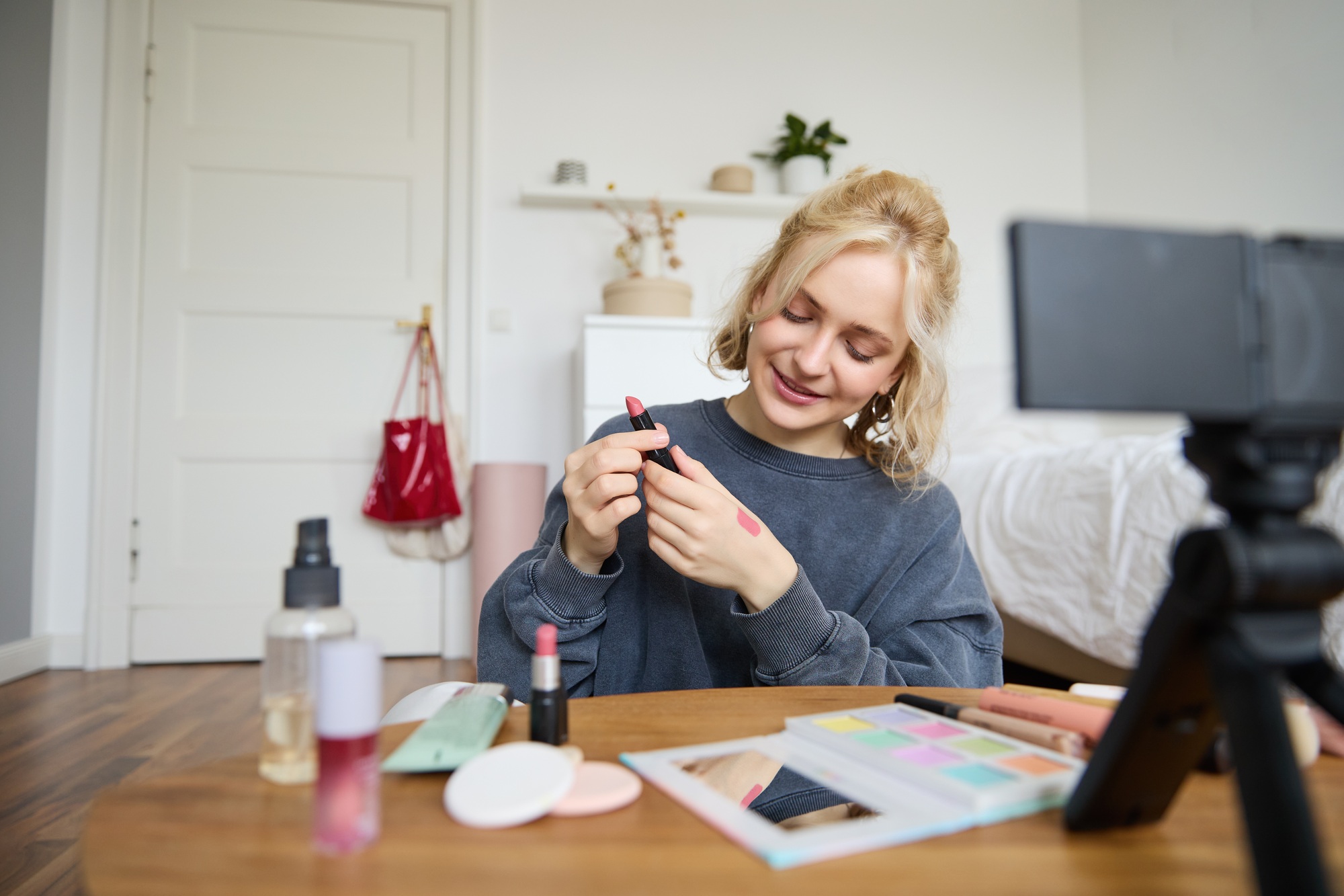 Portrait of beautiful young woman, content creator for social media, sitting in front of digital