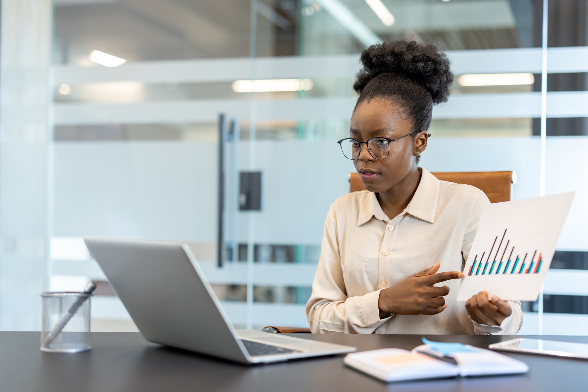 Professional woman presenting data analysis in modern office environment