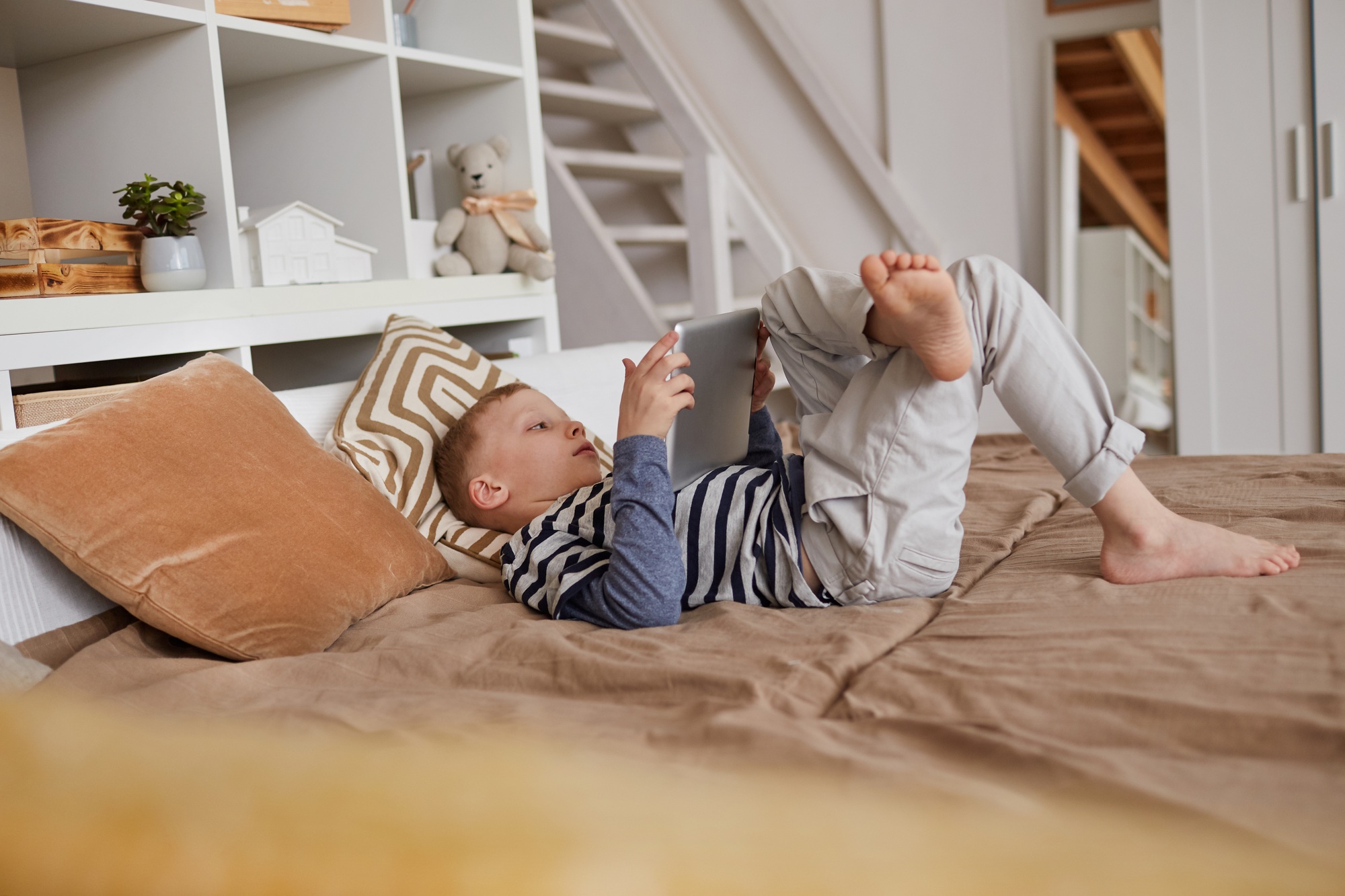 Relaxed boy watching video on tablet