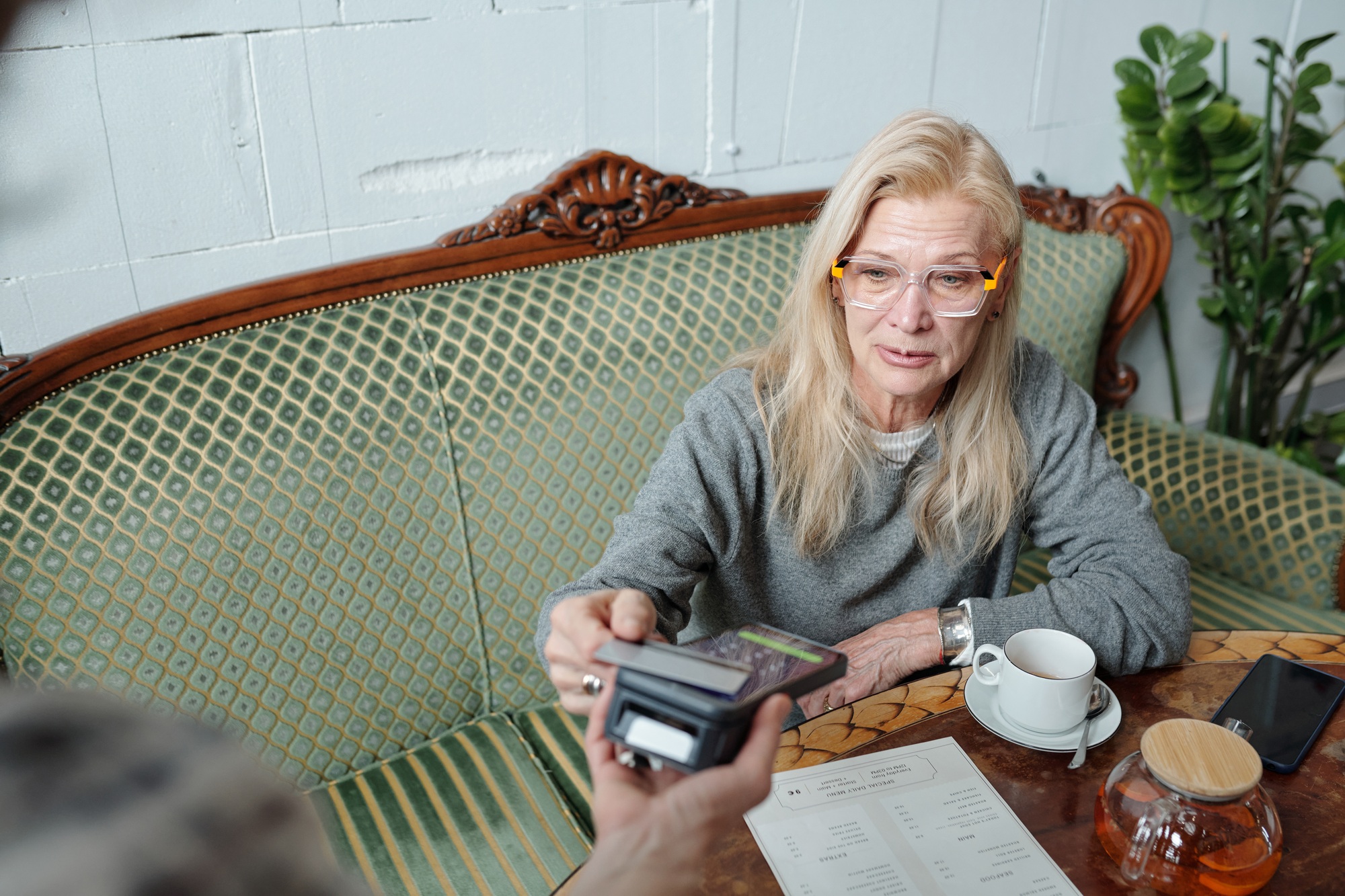 Senior Woman Participating in Point-of-Sale Transaction