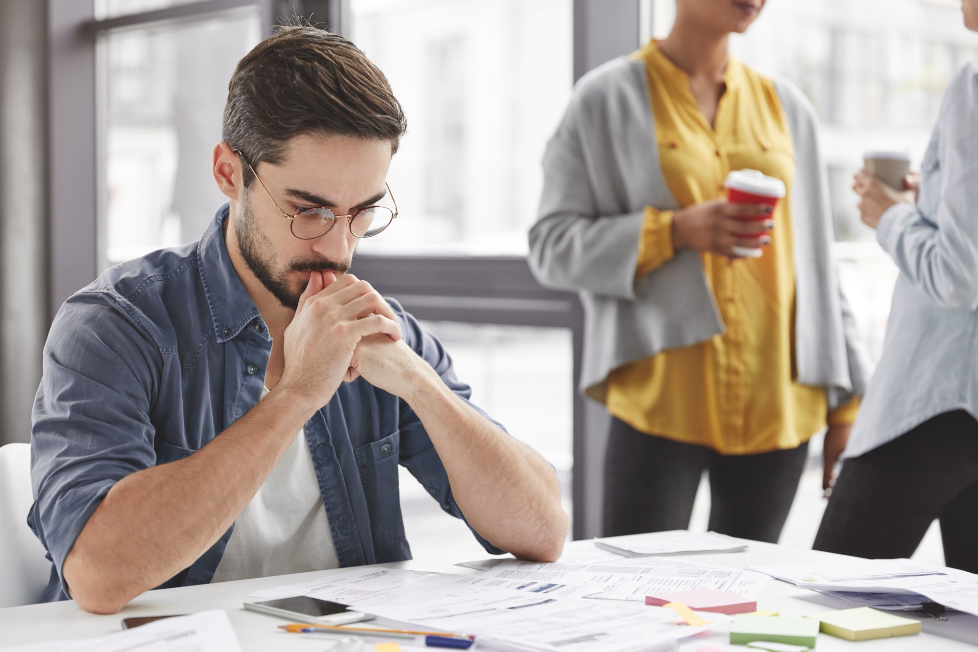 Serious clever experienced male administrative manager plans and coordinates weekly schedule of staf