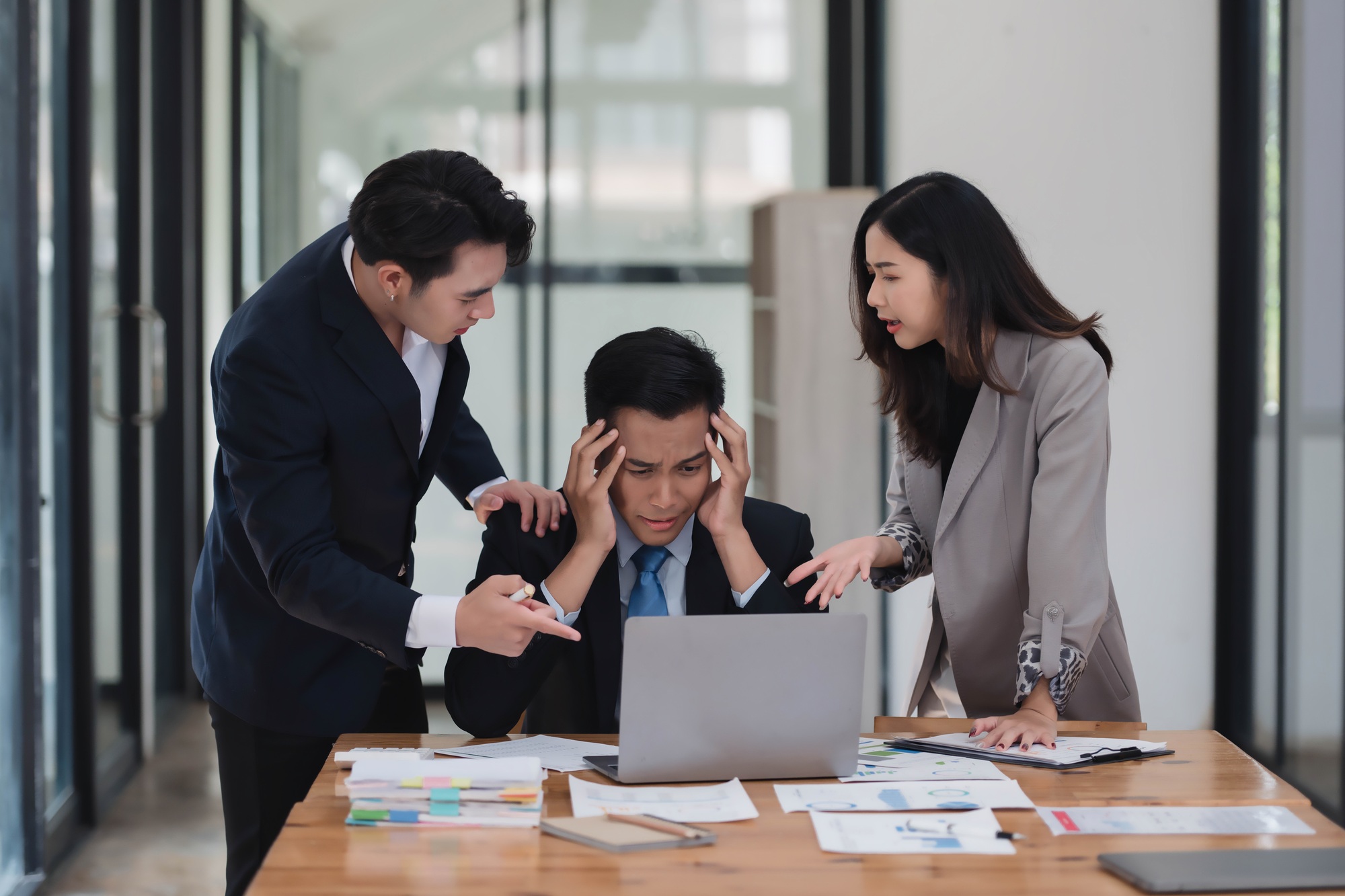 Serious mature Asian male ceo executive manager with business partners discussing corporation busine