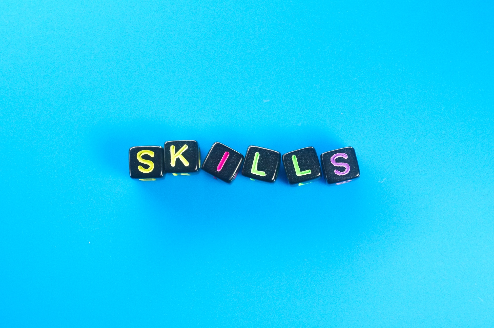 small black cube with the word skills. skill concept