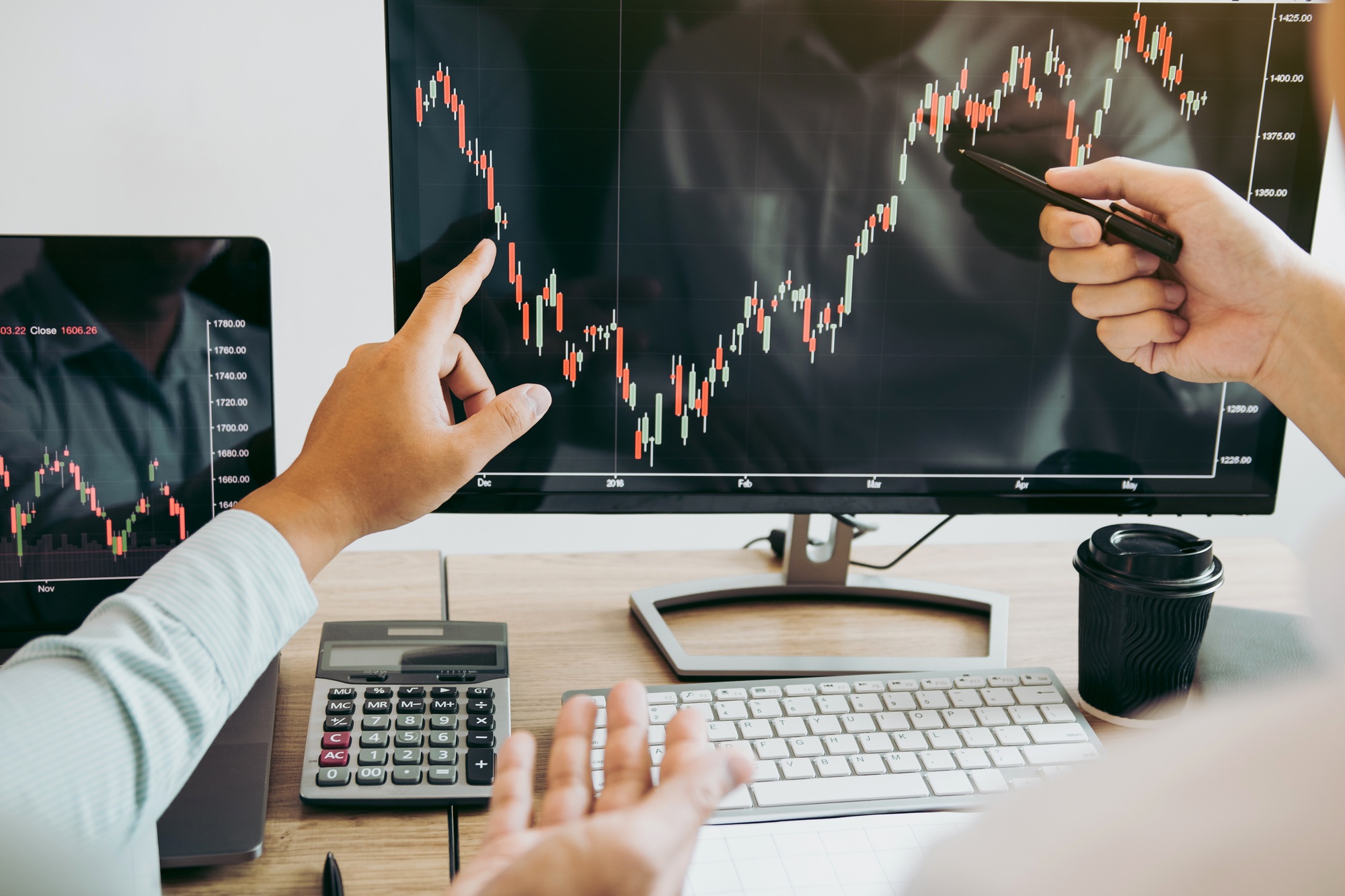 Team of agent trading business people pointing graph and analysis stock market