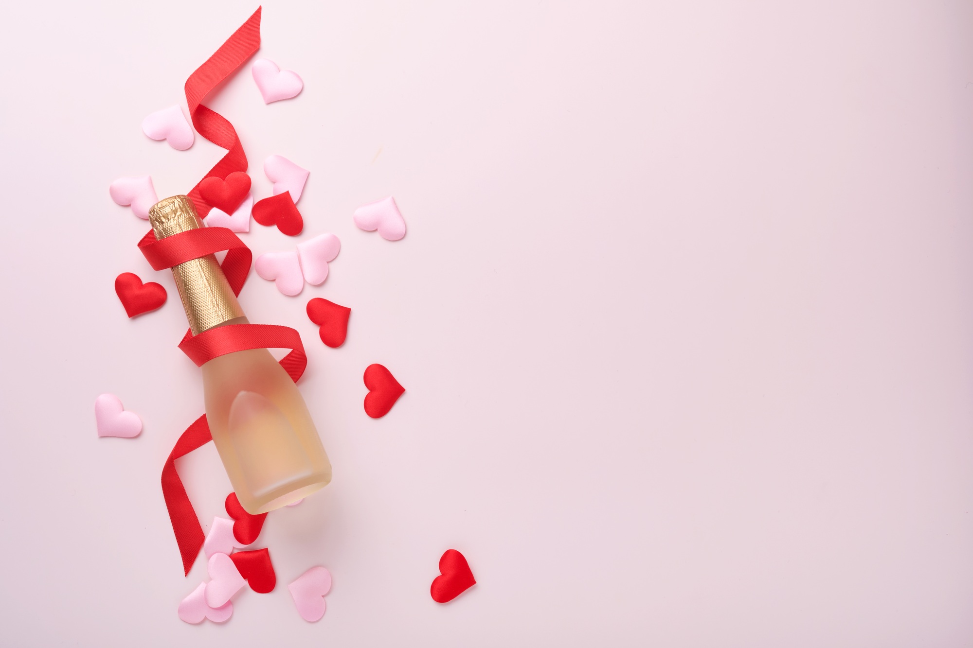 Valentines day greeting card with champagne bottle, gift box, red ribbon and envelope with blank not
