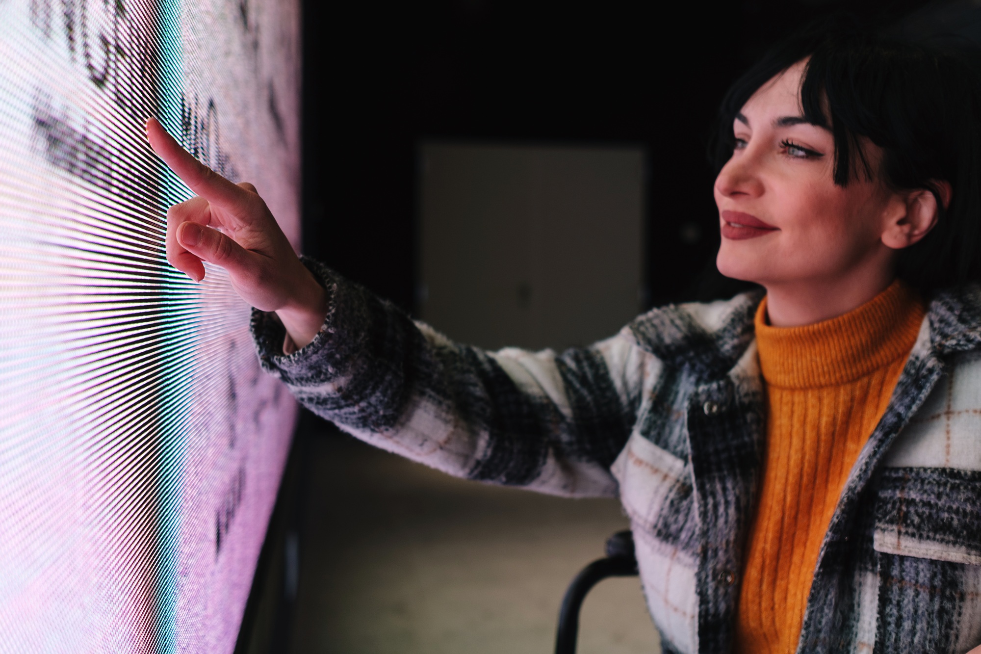 Woman in Wheelchair Interacts with Interactive Digital Exhibit