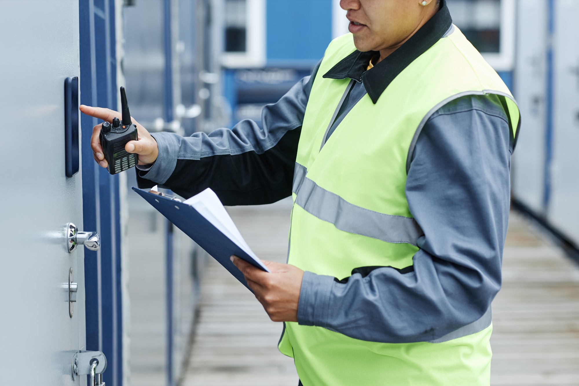 Worker entering key code on storage unit