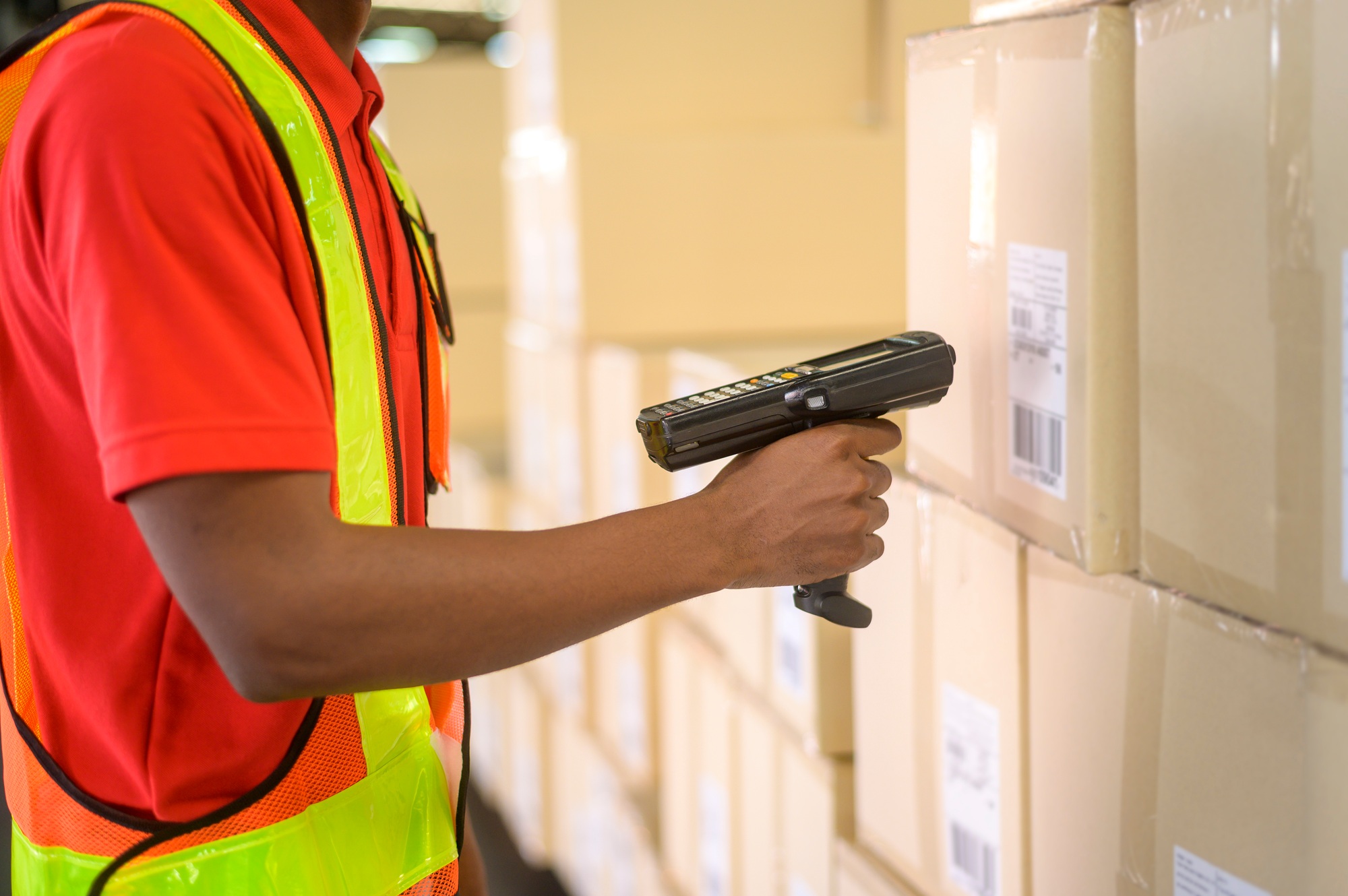 Worker scanning parcels for retail and transport shipping