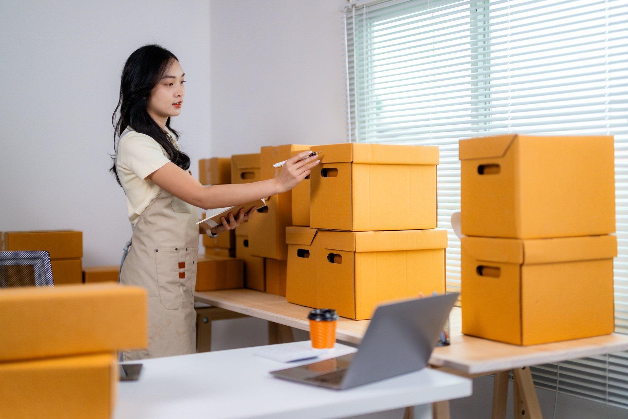 Young Entrepreneur Organizing Inventory in Office Space