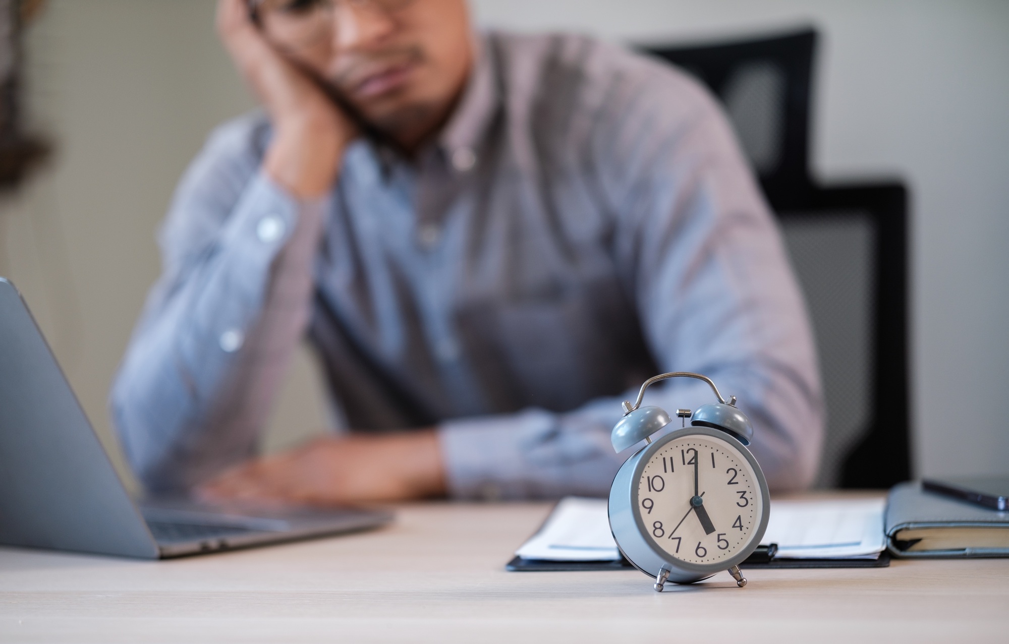 Young male employee in time management concept