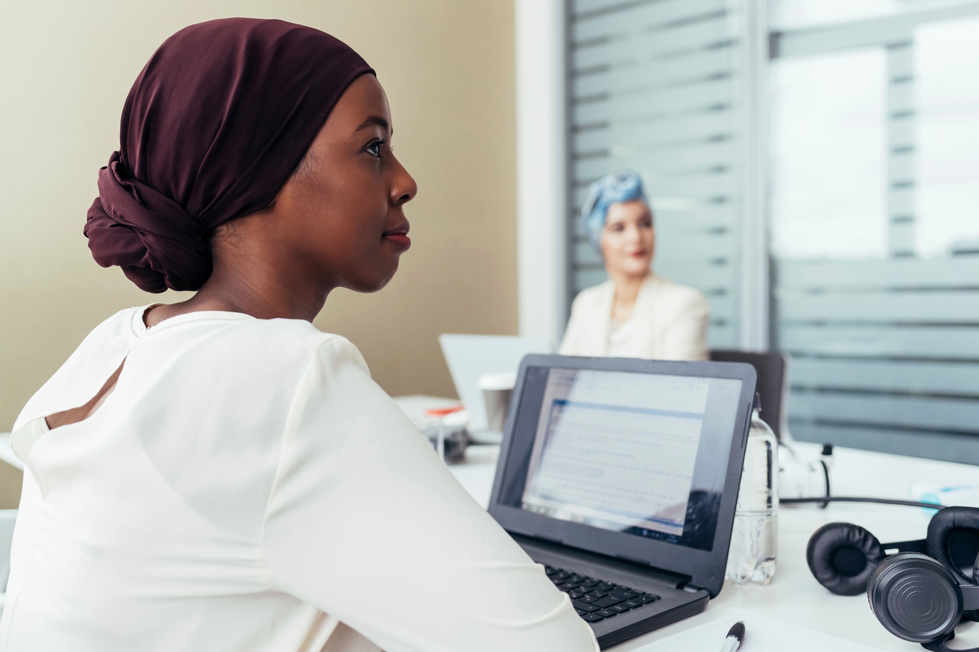 Young professional women engaged in a business meeting.