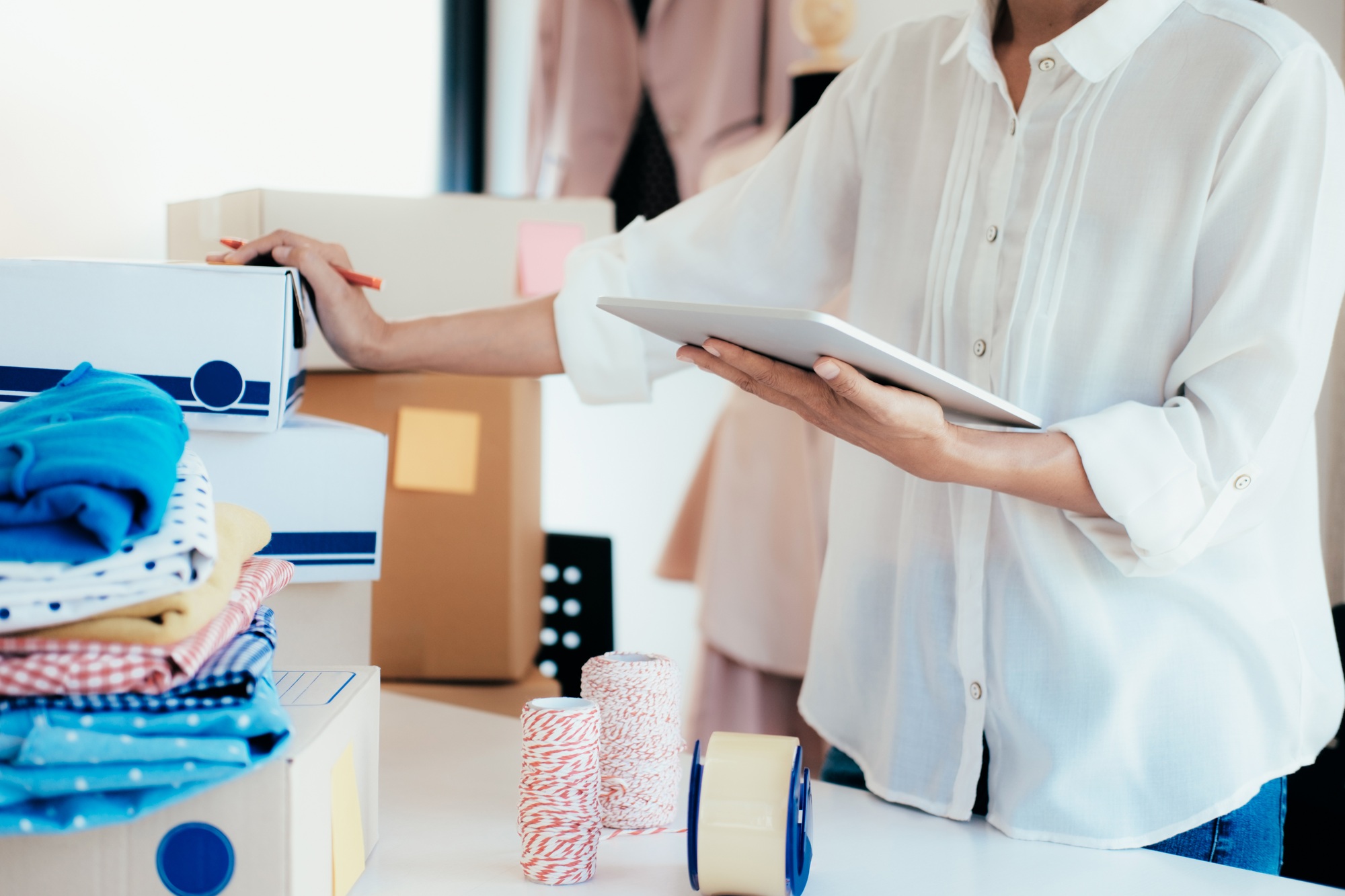 Young small business owner checking list from online order