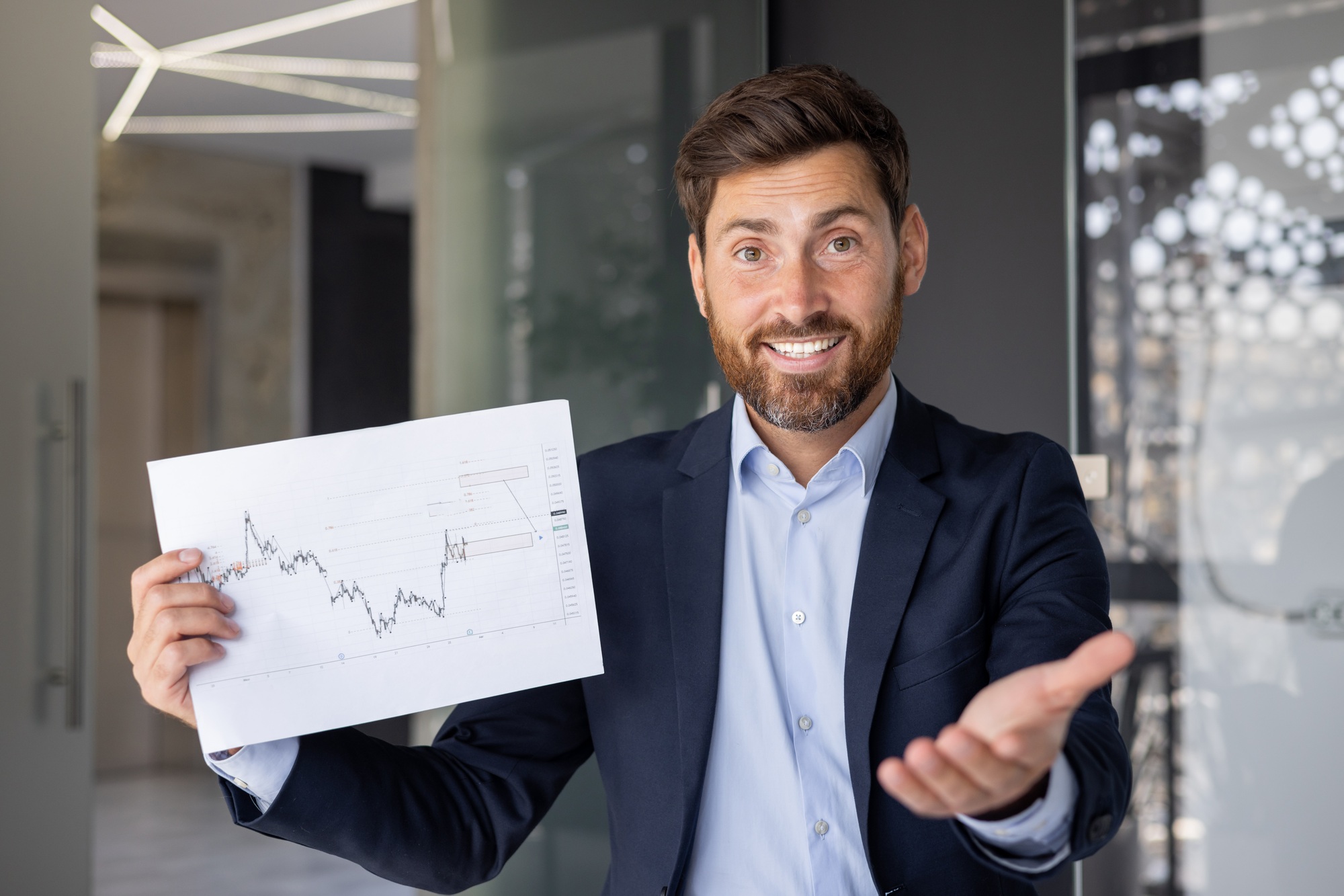 Confident businessman presenting financial chart in office