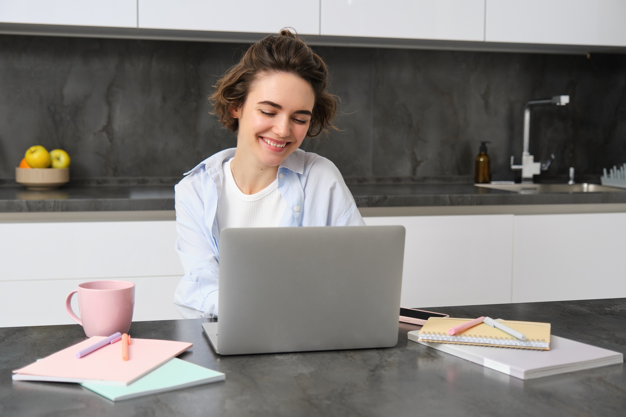 Image of young productive woman works from home, does distance learning, learns online course on