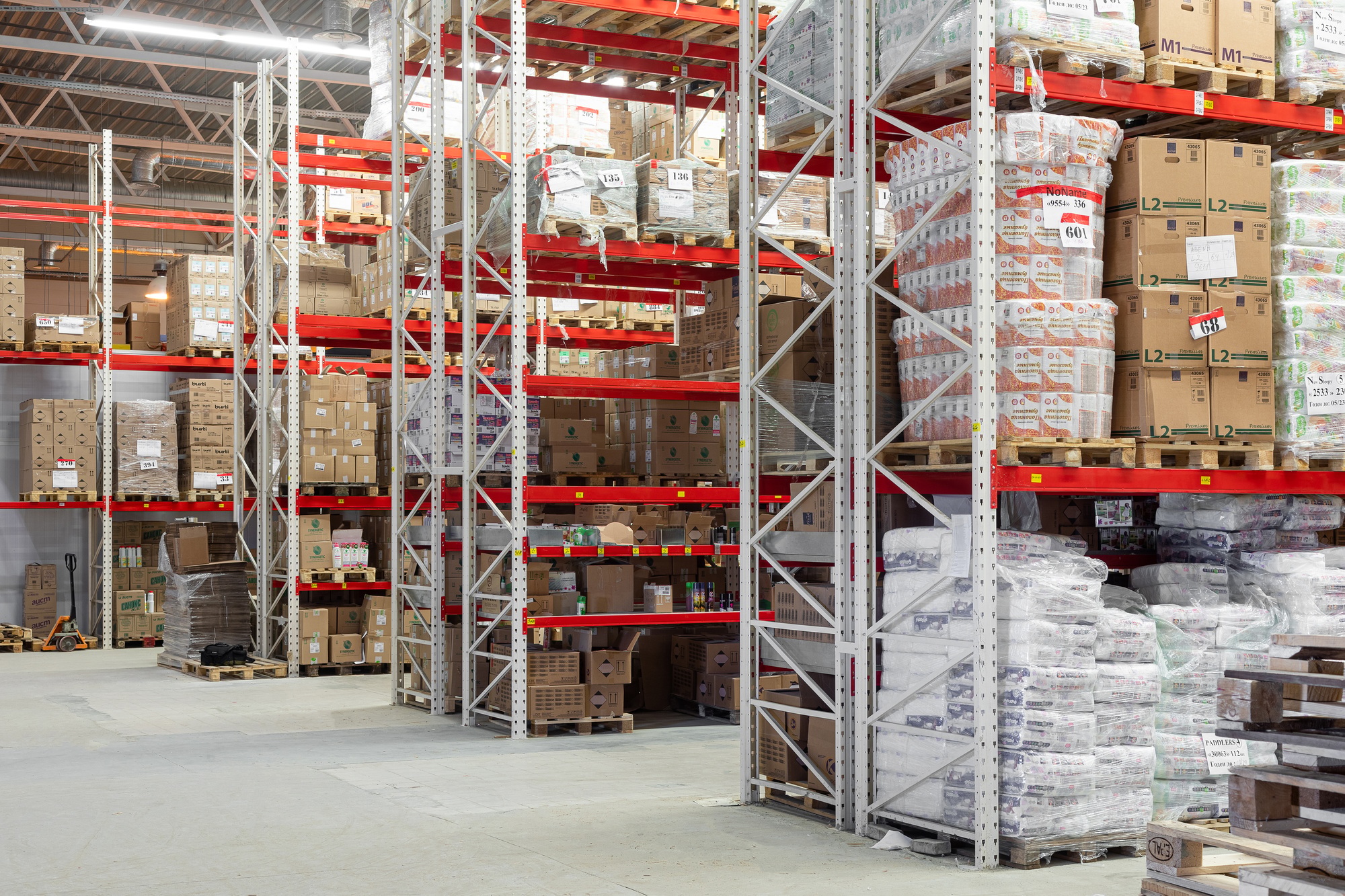 large warehouse with aluminum shelving system and cardboard boxes