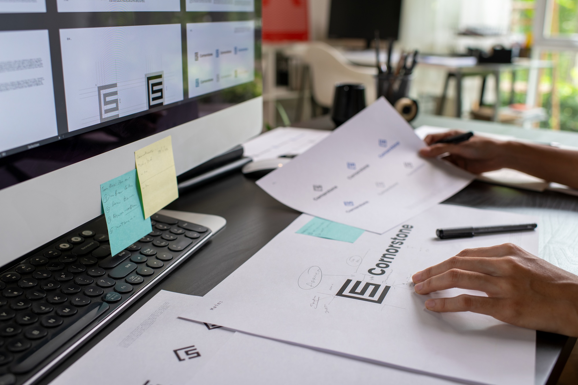 Graphic designer drawing sketches logo design.