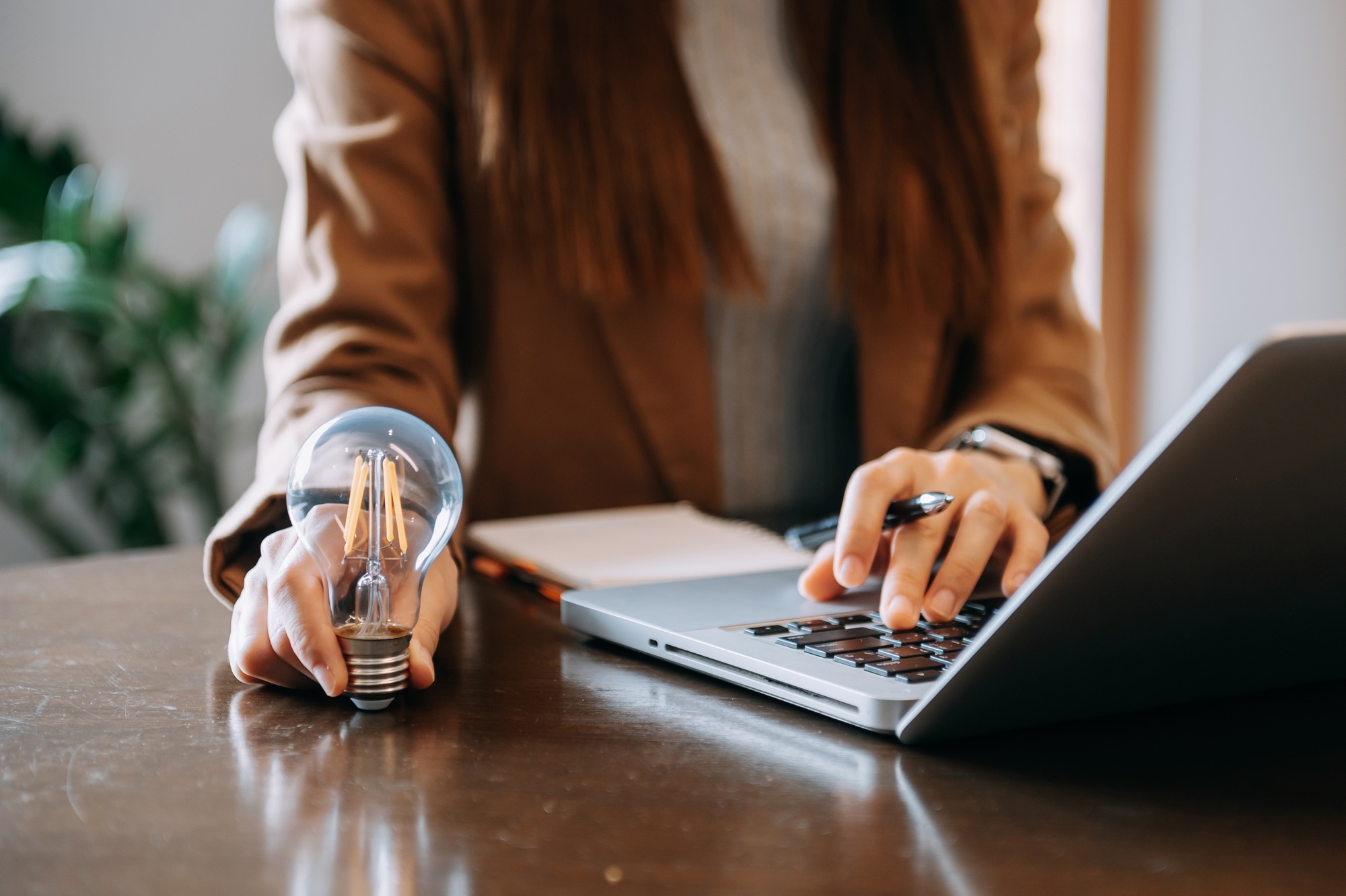 business hand showing creative business strategy with light bulb as concept