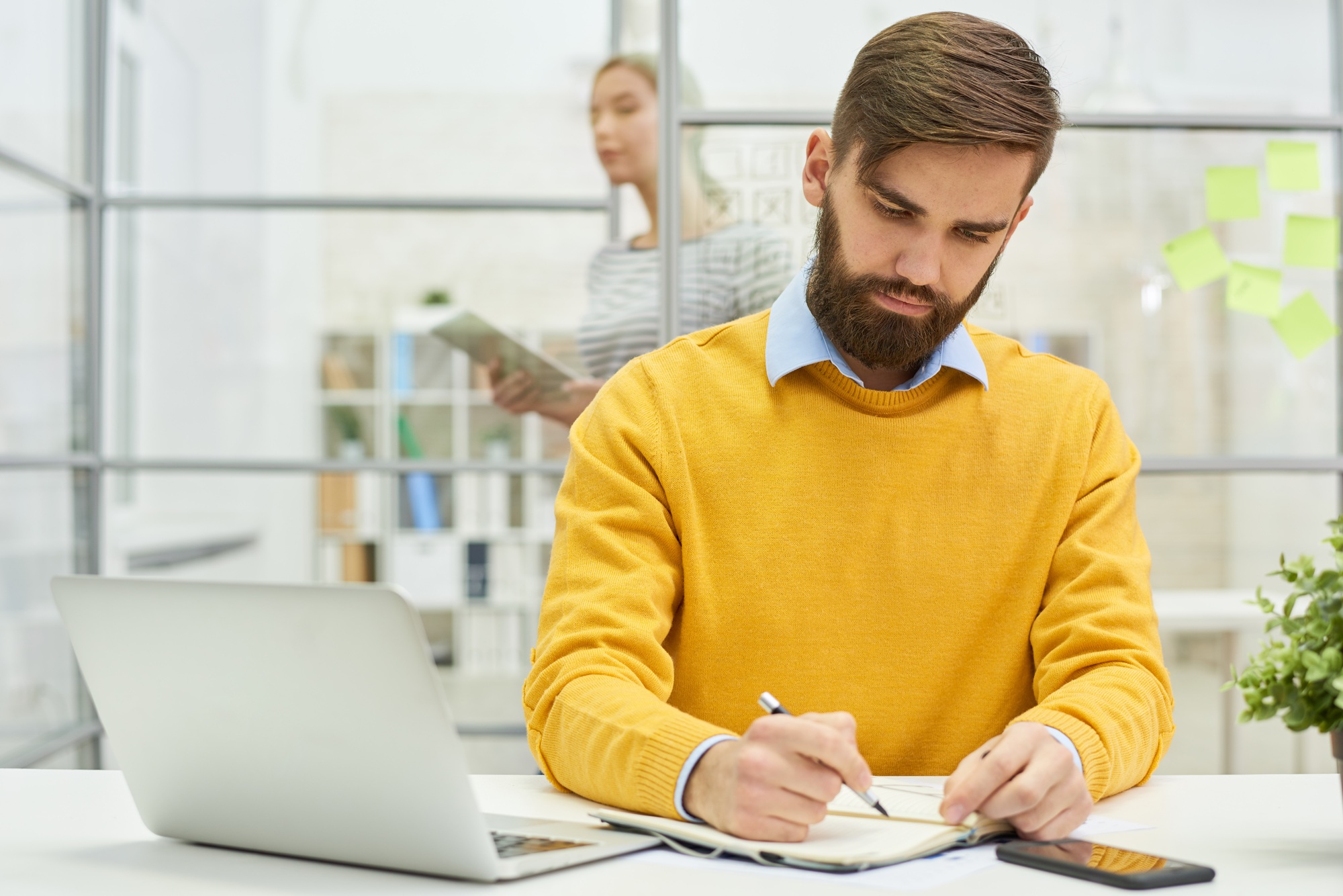 Concentrated male employee planning project schedule