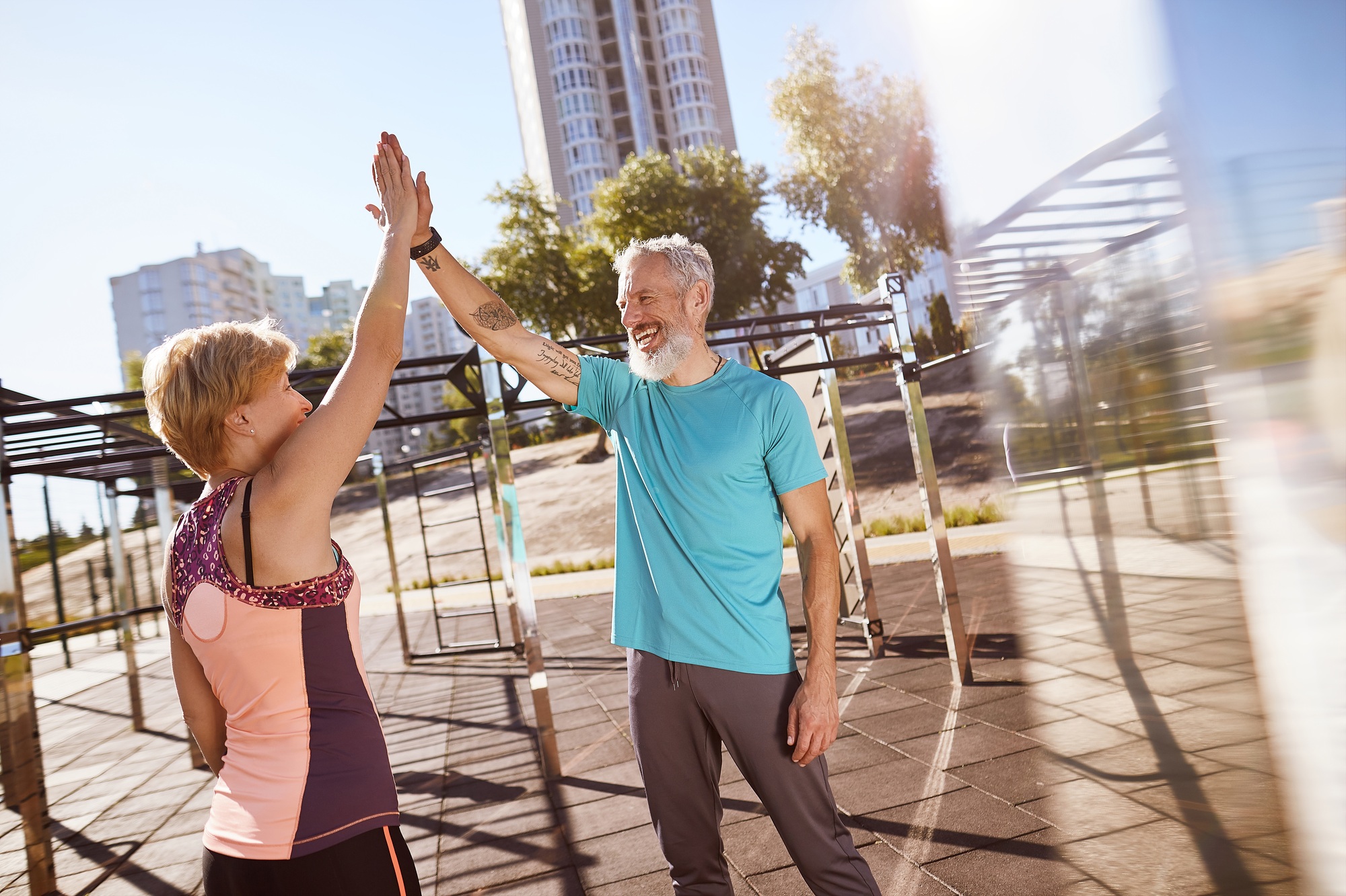 Great morning workout. Happy mature family couple giving high five after successful training