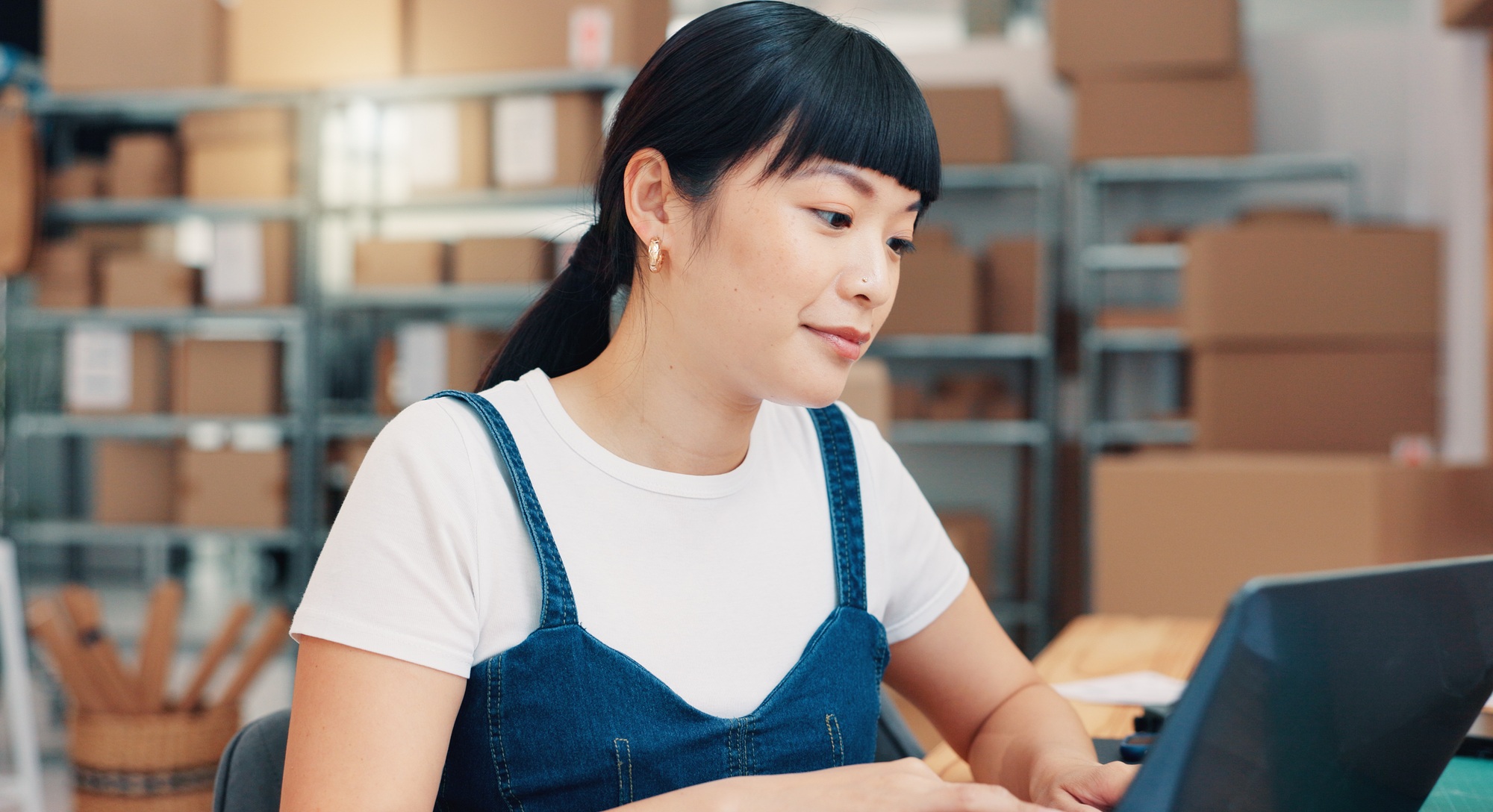 Laptop, schedule and supply chain with asian woman in office for distribution, logistics or supply