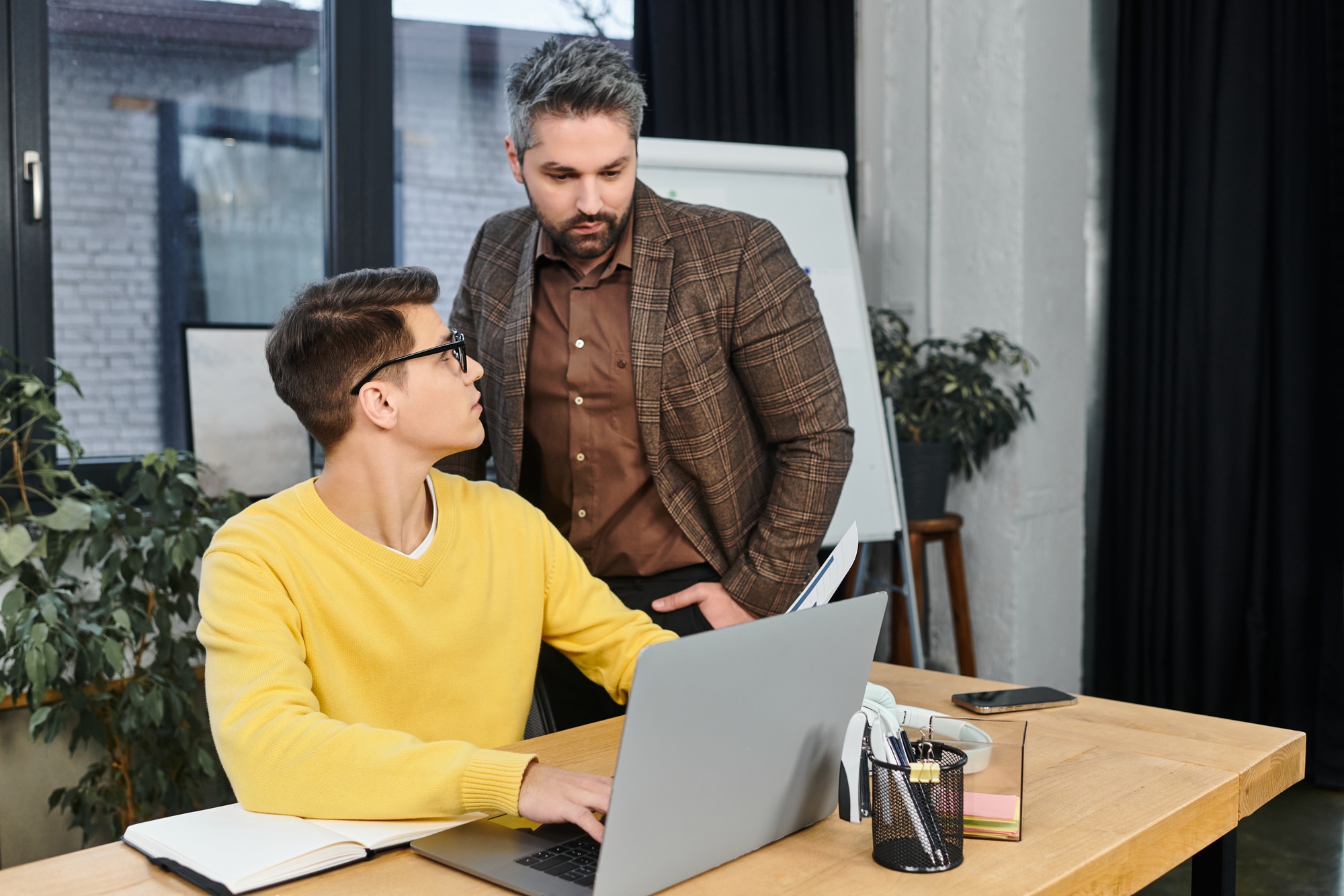 New job orientation in a modern office with a mentor guiding a newcomer on first day