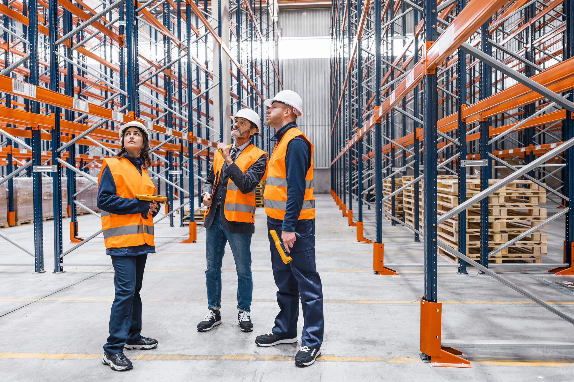 Warehouse workers checking stock and logistics with digital device
