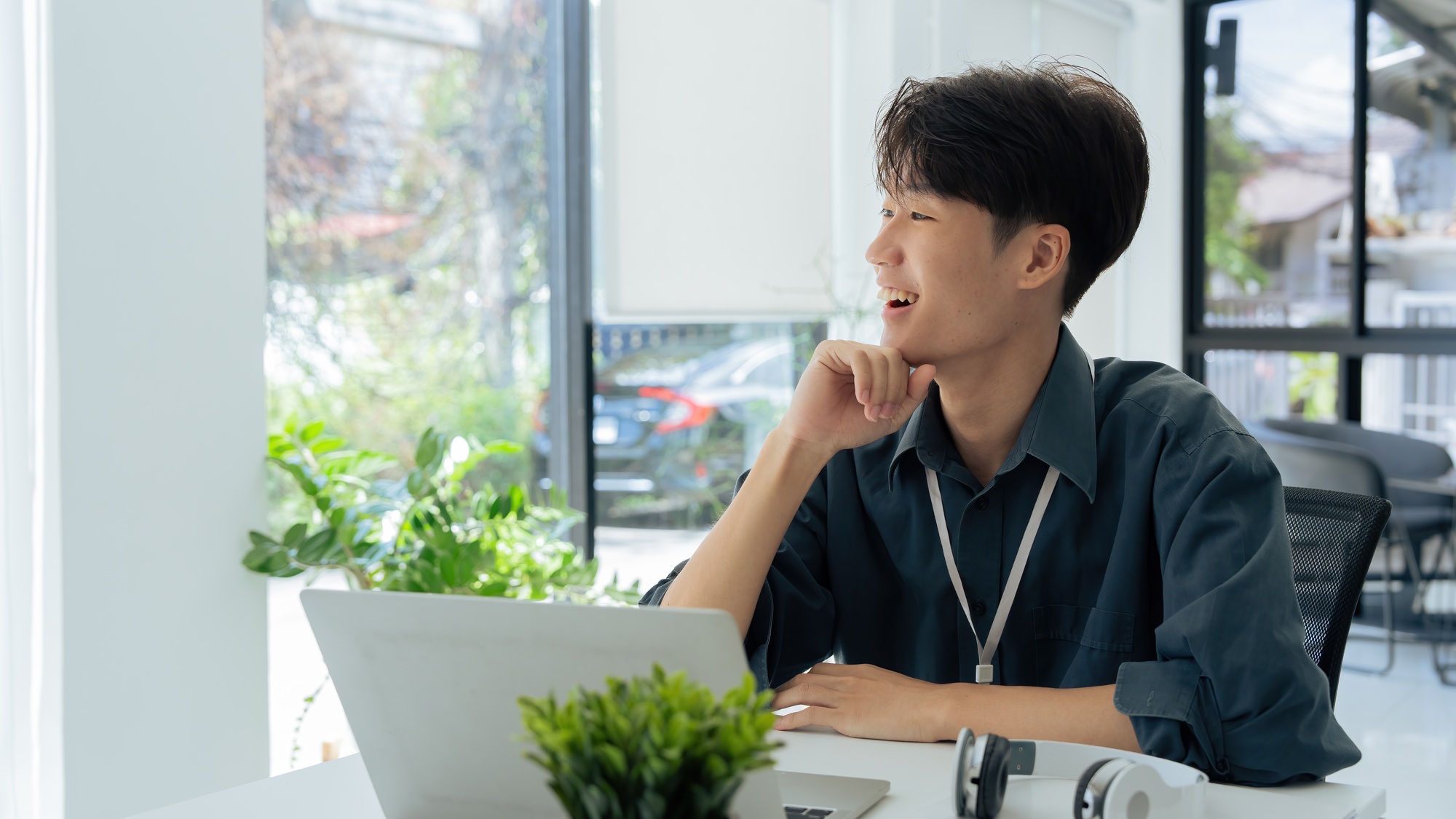 young businessman sitting at desk and working on laptop. employee sitting at the desk and looking